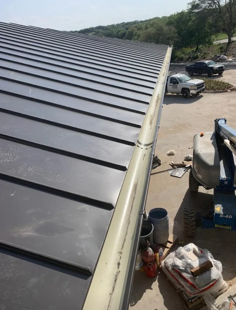 Standing seam panel and gutter detail on a metal roofing jobsite in Orland Park